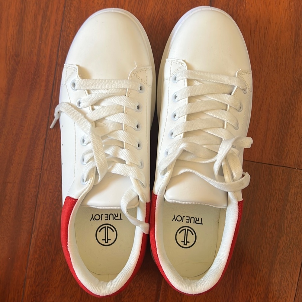 White shoes and a Vans black shoes